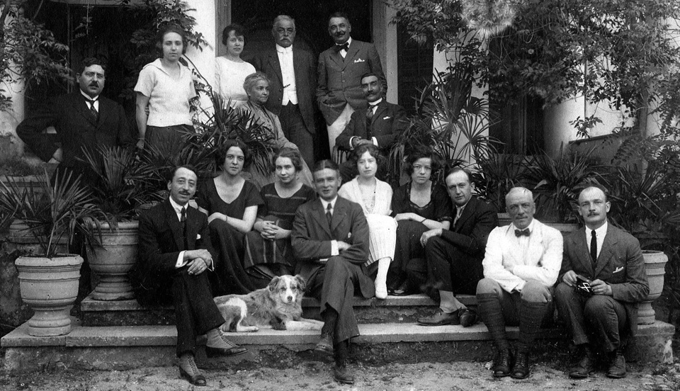 At the Hochepied household, family and friends, Seidikeuy April 1922<br />
left to right, 1st row standing: Mr Langlois, Mlle Jeanne Cua, Ctsse Blanche de Hochepied, Mr Gérard Wissing, Mr Morrin, Inspecteur du Crédit Lyonais.<br />
2nd row sitting: Ctsse Edmond de Hochepied, Mr M Graillet, Consul Génèral du France à Smyrne<br />
3rd row sitting: Ctsse Wemy de Hochepied, Mme Langlois, Mme Léouce Guŷs, Ctsse Elise de Hochepied, Mr L Steeneken.<br />
4th row sitting: M Léouce Guŷs, des Messageries Maritimes; Cte Daniel de Hochepied; Cte Edmond de Hochepied; Mr Tubeuf, du Chemin de fer Smyrne, Cassaba et Prolongement.